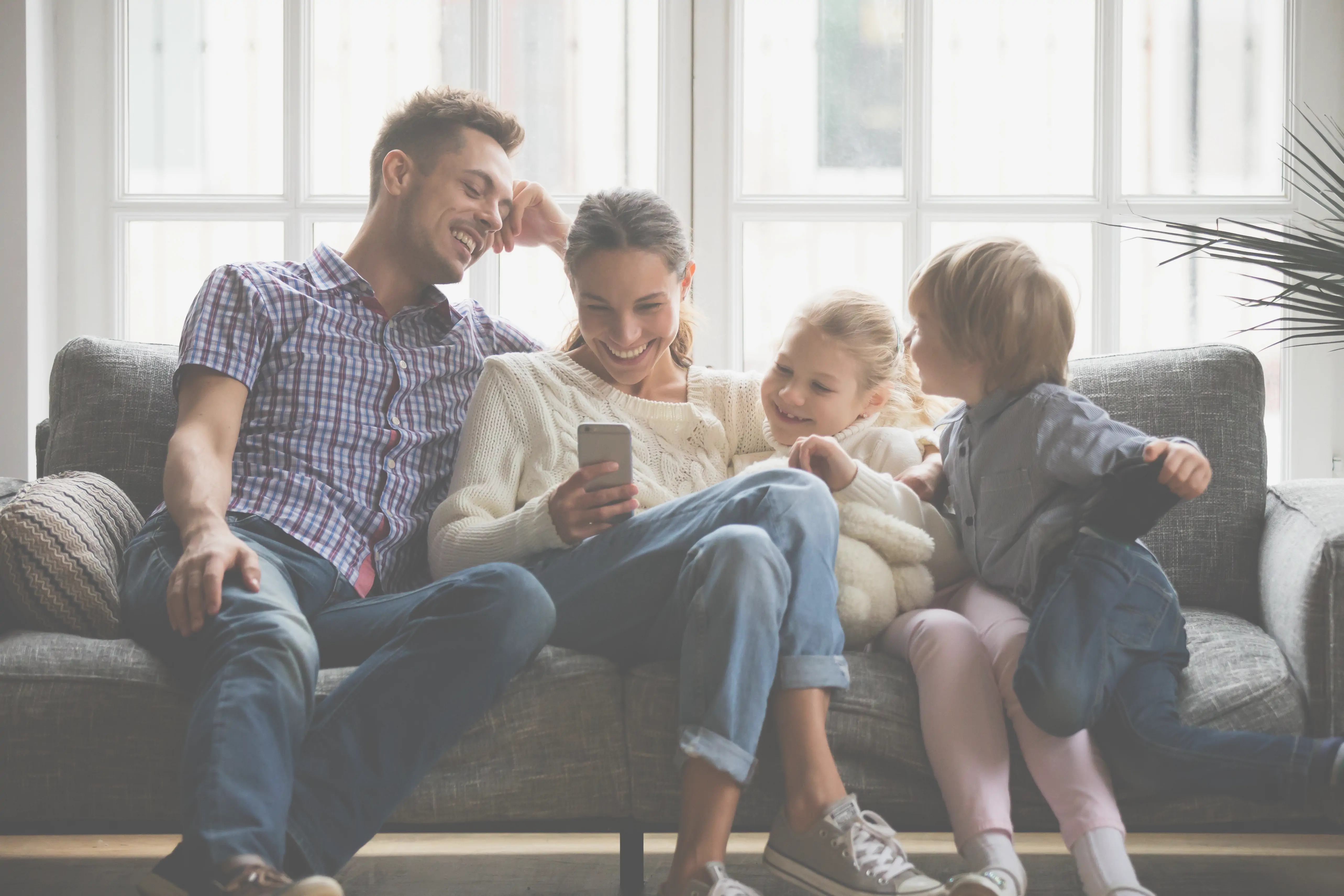 Family relaxing at home after closing on their property